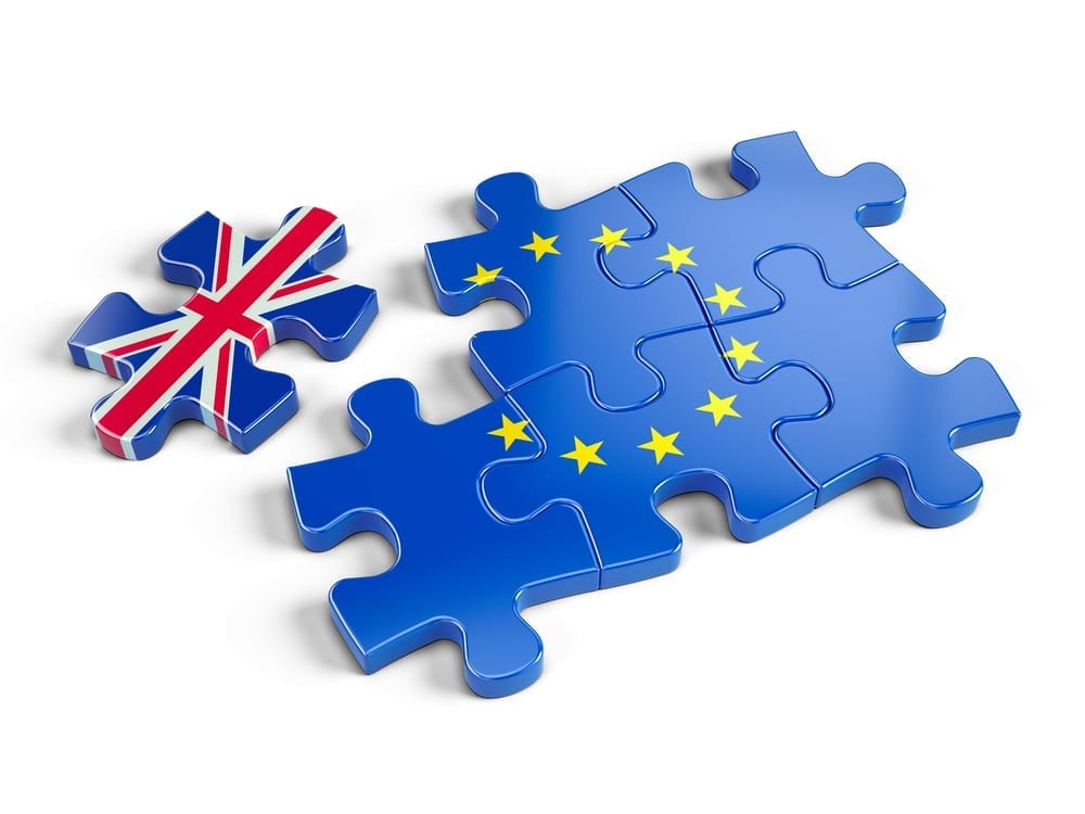 Jigsaw puzzle pieces of European flag with a corner piece with the union jack flag on separated