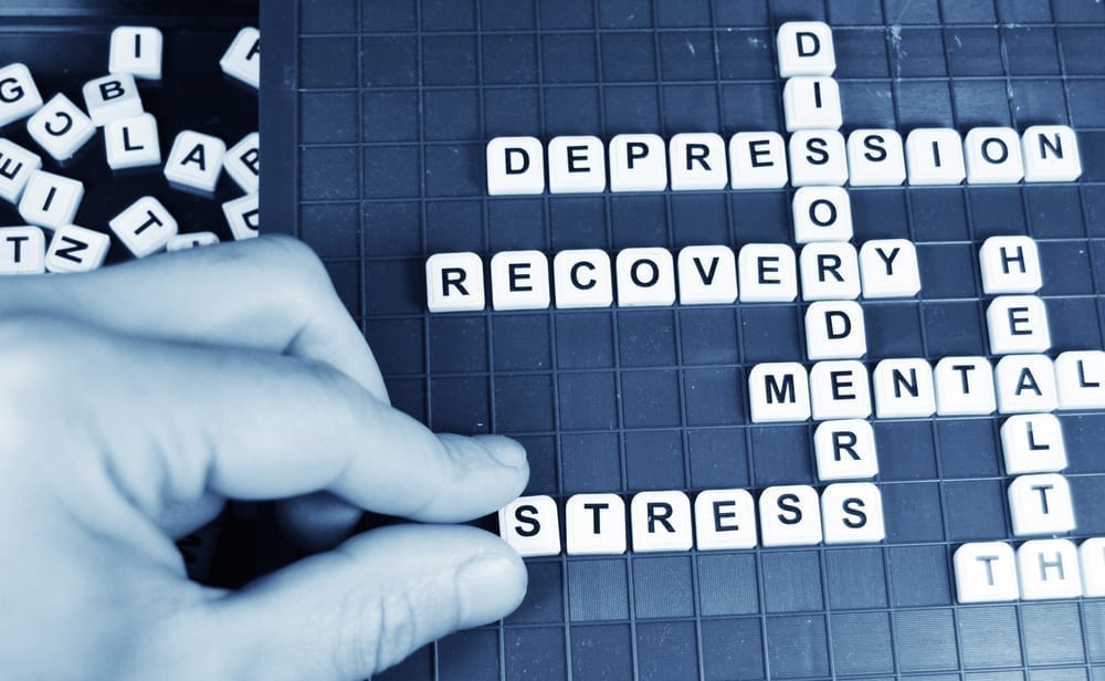 A Scrabble board with the words "Disorder, depression, recovery, mental health and stress"