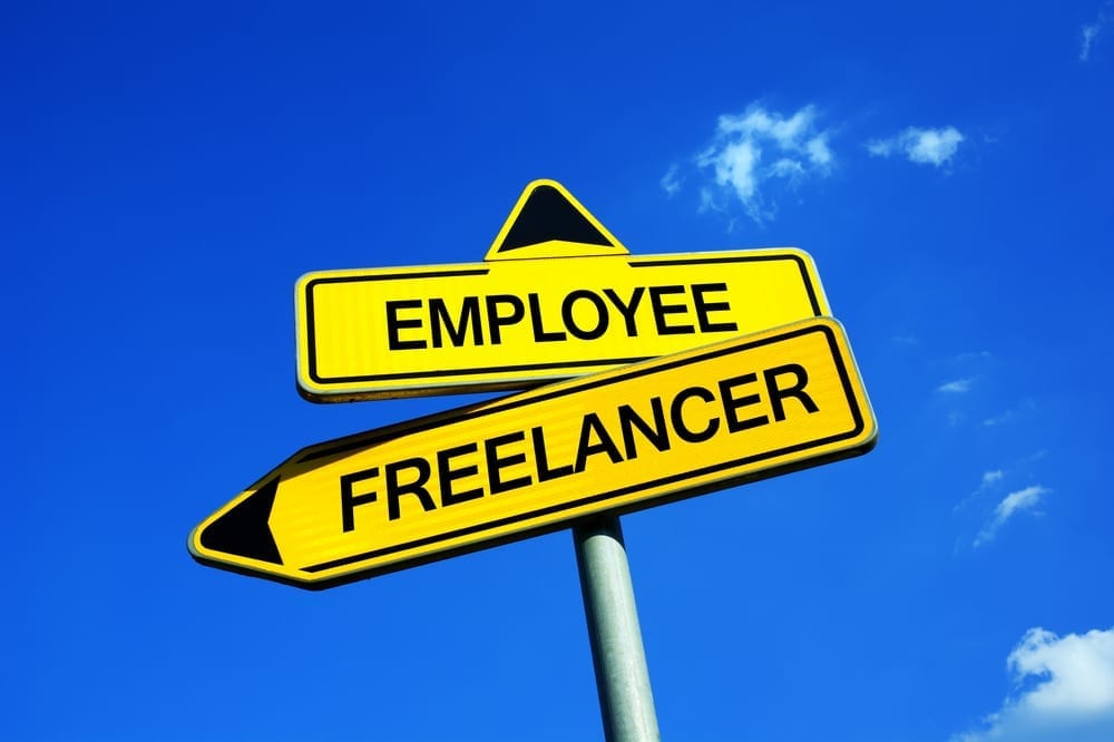 Arrowed road signs reading "Employee" and "Freelancer"