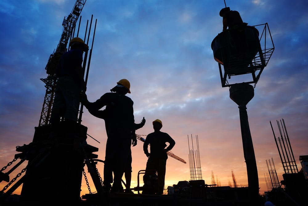 A silhouette photo of construction workers