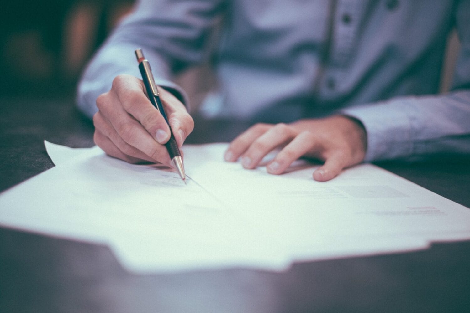 Papers on a desk being signed