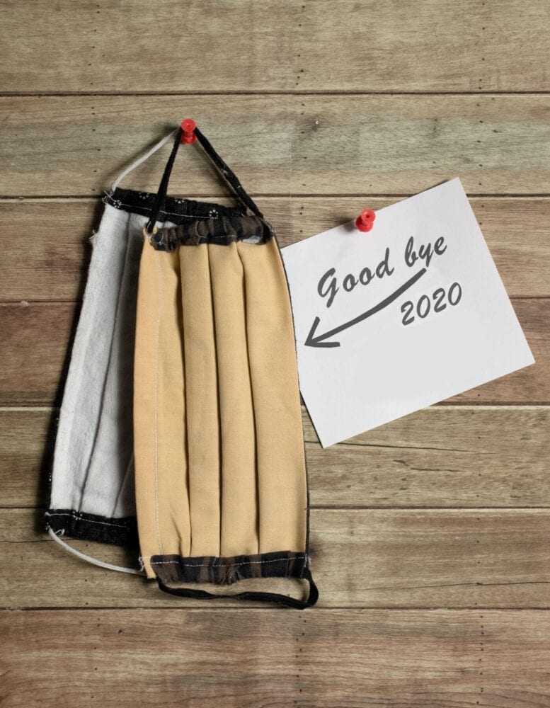 2 masks with a note saying good bye 2020 with an arrow pointing towards the masks