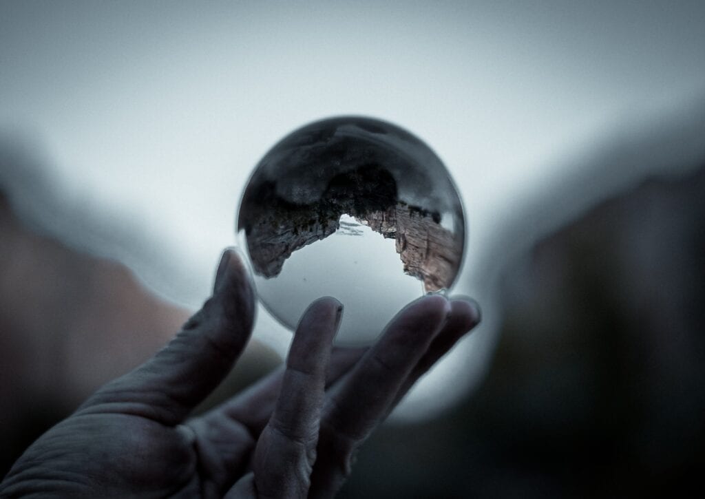 A hand holding a crystal ball